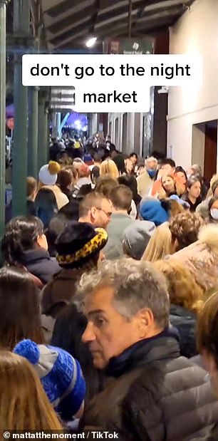 Photos from the night market (above) show long queues and people eating on crowded floors